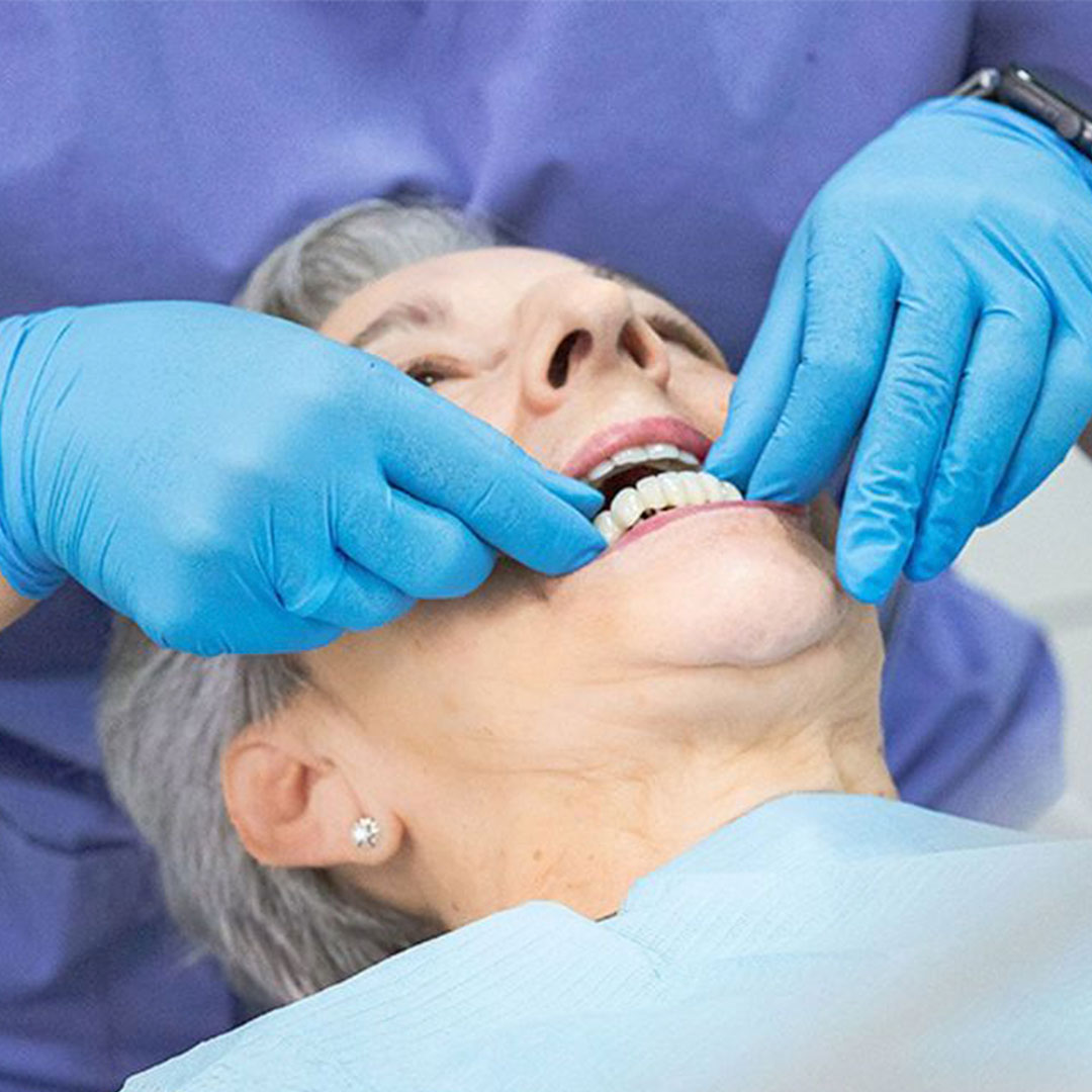 Side-by-side comparison showing the high cost of US dentistry versus affordable dental implant prices in Los Algodones Mexico at a modern clinic.